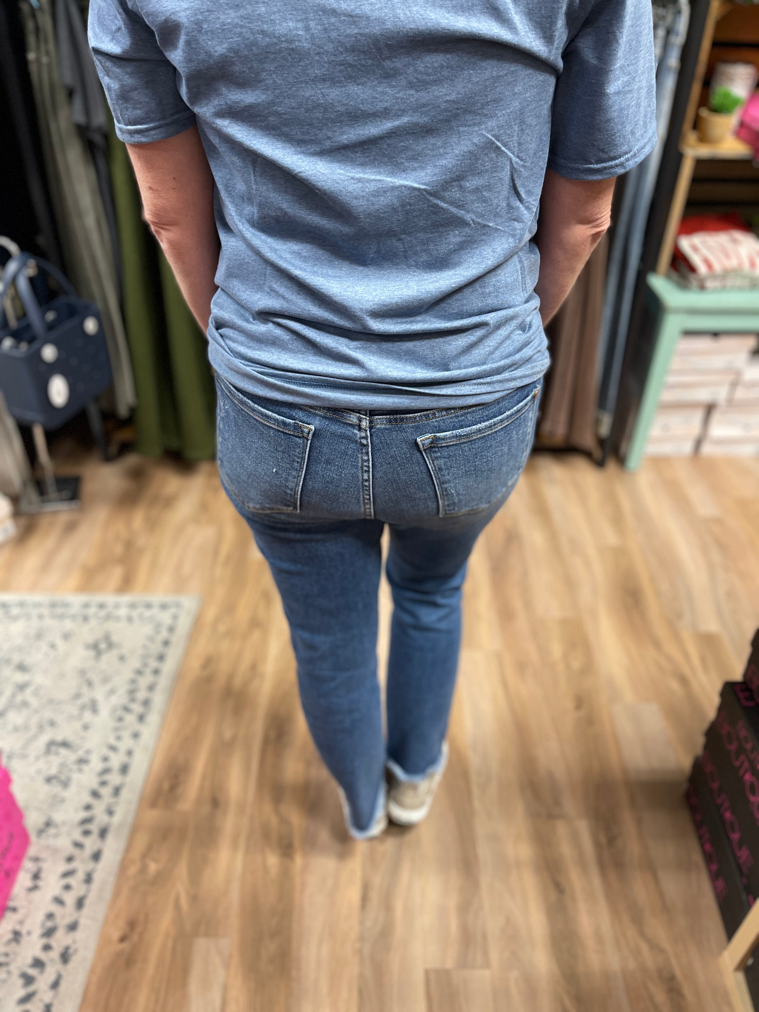 medium wash denim, tan side stitching along both side hems, Howdy embroidered on right pocket