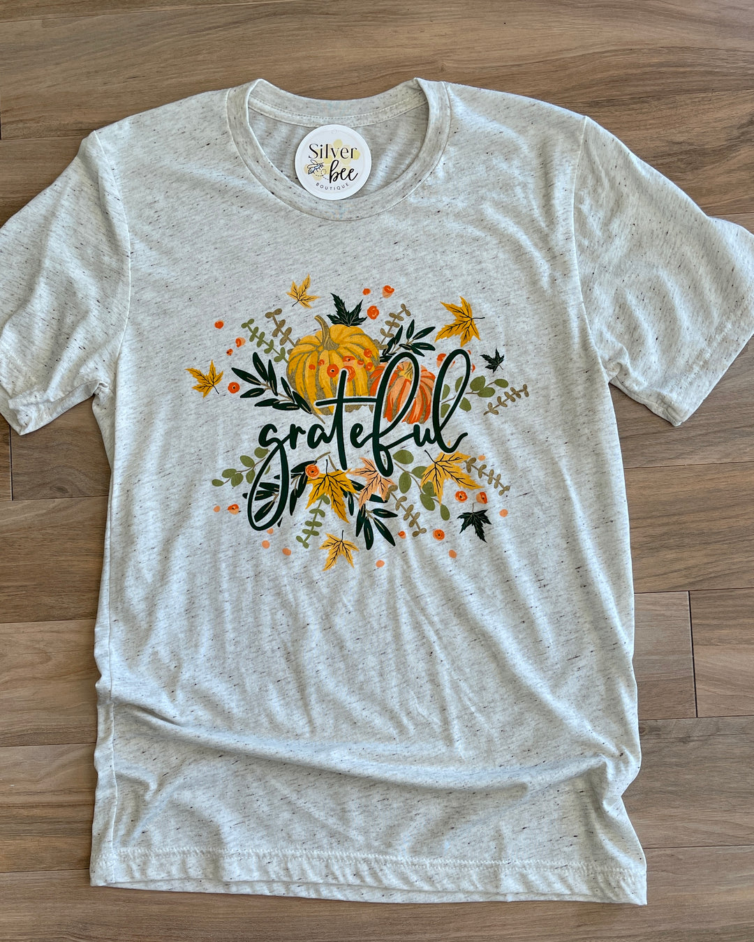 heathered cream colored tee, grateful text, fall leaves and pumpkins graphics