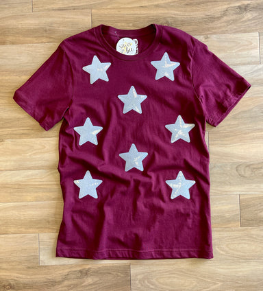 maroon tee with white iridescant stars sewn onto front of tee, short sleeve tee
