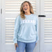 light blue, long sleeve crew neck sweatshirt with the word TEXAS in white embroidered lettering