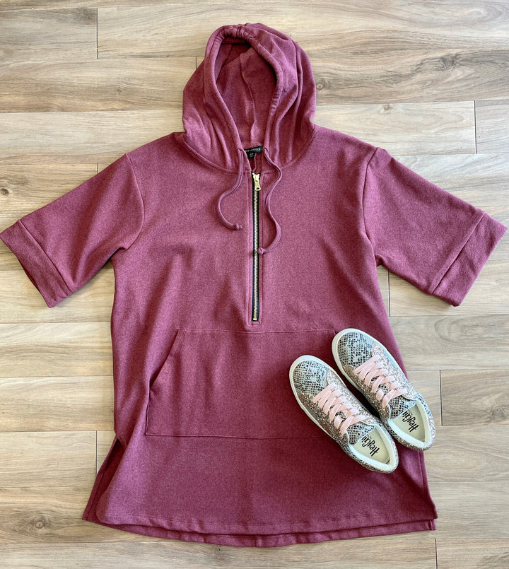 brick red/maroon color short sleeve sweatshirt with hoodie, half zip, front pocket, side slits, longer length to cover upper thighs